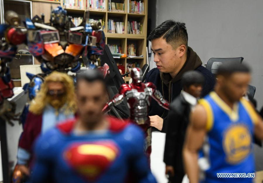 Zeng Zhou works on the design of toy figures at a cultural industrial park in Chengdu, southwest China's Sichuan Province, Feb. 4, 2021. Zeng Zhou is a 31-year-old independent designer working on toy figure design. Inspired by a visiting experience at Sanxingdui Museum in Sichuan, Zeng decided to design model figures imitating bronze relics of the Sanxingdui Ruins, which are believed to be remnants of the Shu Kingdom dating back 2,600 years to 4,800 years, blending traditional Chinese culture with fashion toys. Zeng Zhou is now dedicated to optimizing his design and promoting mass production of his toy figures. 